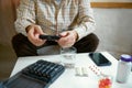 Hands of a senior man holding pill box, medication containers labeled with days of week. Organizer for daily pills and Royalty Free Stock Photo