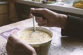 Hands of the senior man during a lunch consisting of cheap noodle soup