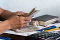 Hands of a senior woman counting money upon a desk Royalty Free Stock Photo