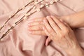 Hands of a senior woman with nude manicure Royalty Free Stock Photo