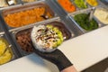 Hands serving Hawaiian Poke seen from above