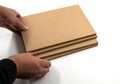 Hands set up four boards of raw MDF. Royalty Free Stock Photo