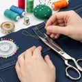 Hands sewing denim with scissors and thread Royalty Free Stock Photo