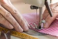 Hands at sewing machine holding some fabric Royalty Free Stock Photo