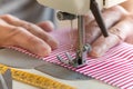 Hands at sewing machine holding some fabric Royalty Free Stock Photo