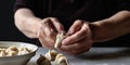 Hands shape a doughy mixture into perfect dumplings, following a precise folding technique, concept of Traditional