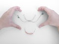 Hands in shape of heart around orthodontic device,metal braces for upper teeth,flesh-colored plastic cap for lower teeth