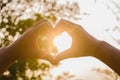 Hands in shape of love heart and sunshine Royalty Free Stock Photo