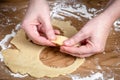 Hands Shaping Raw Dough Circle on Floured Wooden Surface During Pastry Preparation Royalty Free Stock Photo