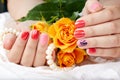 Hands with short manicured nails colored with pink and red nail polish Royalty Free Stock Photo