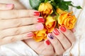 Hands with short manicured nails colored with pink and red nail polish Royalty Free Stock Photo