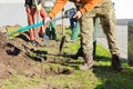 Hands with a shovels. Group of diverse people digging hole planting tree together, volunteering, charity, people and ecology Royalty Free Stock Photo