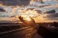 Hands show the spring sun sunset