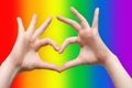 Hands showing heart sign on LGBT rainbow background. Sexual minority, homosexuality and equal rights concept Royalty Free Stock Photo