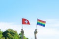 Hands showing LGBTQ Rainbow and Switzerland flag on nature background. Support Lesbian, Gay, Bisexual, Transgender and Queer Royalty Free Stock Photo