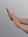 Hands showing a refuse, defense or stop hand gesture sign on a light gray background Royalty Free Stock Photo