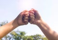 Hands showing thumbs sign together with sun light on sky  background Royalty Free Stock Photo