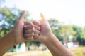 Hands showing thumbs sign together with sun light on sky  background Royalty Free Stock Photo