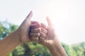 Hands showing thumbs sign together with sun light on sky background. Royalty Free Stock Photo