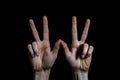 Hands showing victory sign on a black background, close-up, Variation hands with a peace sign, AI Generated