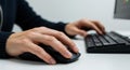 Typing Hands on Black Keyboard Using Mouse on White Desk Royalty Free Stock Photo