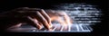 Fingers Typing Rapidly on a Laptop Keyboard With Glowing Code Data in a Dark Environment at Night Royalty Free Stock Photo