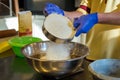 Hands Sift flour in bowl