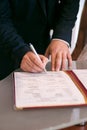 Hands sign a document