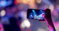 Hands silhouette recording video of live music concert with smartphone. Royalty Free Stock Photo