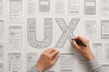 Hands sketching UX wireframes and user interface designs on a wall user experience Royalty Free Stock Photo