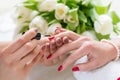 Hands of a skilled manicurist applying red nail polish on nails Royalty Free Stock Photo