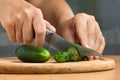 Hands slicing cucumber, closeup Royalty Free Stock Photo