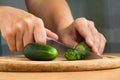 Hands slicing cucumber for salad Royalty Free Stock Photo