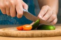 Hands slicing cucumber and tomato on the cutting board Royalty Free Stock Photo