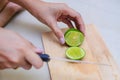 Hands slicing a lime with a chef knife Royalty Free Stock Photo