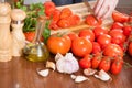 Hands slicing tomatoes at table Royalty Free Stock Photo