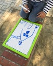 Hands of small student drawing on whiteboards