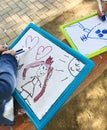 Hands of small student drawing on whiteboards