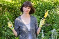 In the hands of a smiling adult girl, gardening tools for working in the garden. Royalty Free Stock Photo