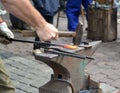 Hands of the smith forge the heated metal detail