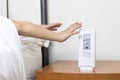 Hands snooze alarm clock in the morning Royalty Free Stock Photo