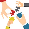 Hands solving jigsaw