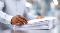 Hands Sorting Through a Stack of Papers at an Office Desk During a Busy Workday Royalty Free Stock Photo