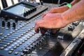 Hands on sound board mixer adjusting sound levels up close Royalty Free Stock Photo