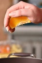Hands squeeze juice from fresh and juicy orange Royalty Free Stock Photo