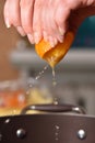 Hands squeeze juice from fresh and juicy orange Royalty Free Stock Photo