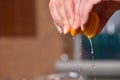 Hands squeeze juice from fresh and juicy orange Royalty Free Stock Photo