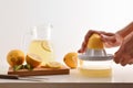 Hands squeezing a lemon on bench isolated white background Royalty Free Stock Photo