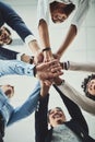 Hands stacked and piled showing team unity, strength or motivation among creative business colleagues from below Royalty Free Stock Photo