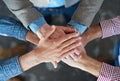 Hands stacked and piled to show team unity, strength and motivation among business men, colleagues and coworkers. Above Royalty Free Stock Photo